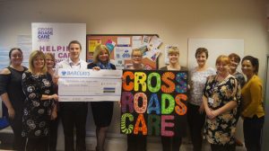 Claire Austin hands a £5,000 cheque to Andrew Taylor, operations manager at Crossroads Care Hertfordshire North